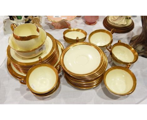 A Royal Doulton china tea service for 12 persons, on ivory ground with tooled gilt borders 