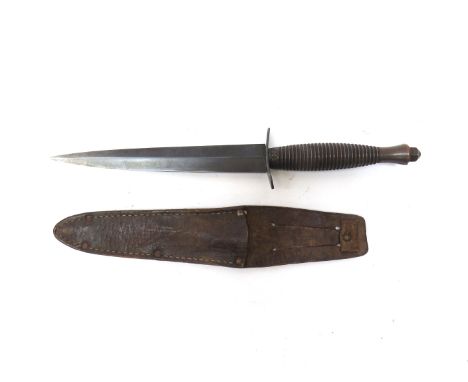 A Fairbairn Sykes Third pattern commando dagger, non-matching sheath, blade tip bent out of shape slightly