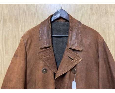 A Royal Flying Corps (RFC) style officer's coat, tan leather with fleeced lining, broad arrow to inside 