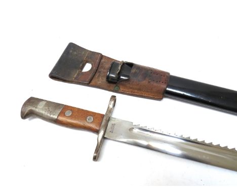 A Swiss M1914 Sawback bayonet, the blade by Elsener Schwyz, black painted metal scabbard, with brown leather belt frog 