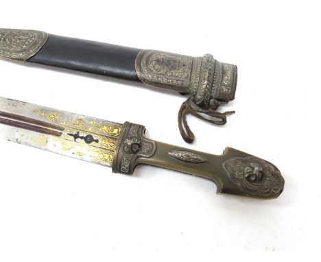 A 19th Century Islamic dagger, the horn grip with applied silver joining a twin fuller blade overlaid with gold, with silver 