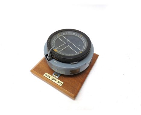 A WWII RAF P11 pilot's compass circa 1944, stamped 6A/0.726, mounted on oak plinth