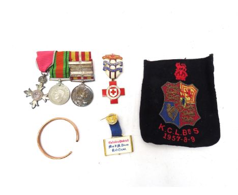 A medal group of three consisting of Civil MBE, WWII Defence Medal and Voluntary Medical Service Medal with five Red Cross cl