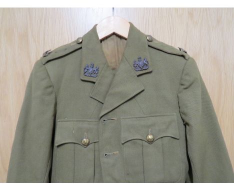 A WWII British Army Officers jacket, trousers and belt with insignia named to W.G. CHESTER Provenance - Serviceman listed as 