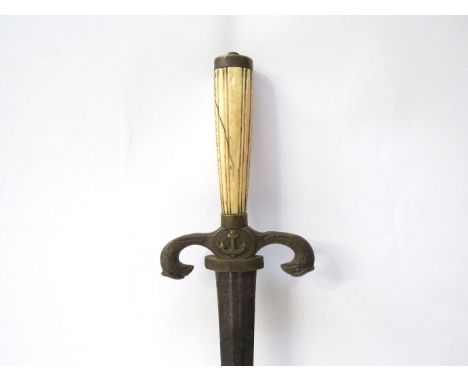 A 19th Century Naval officer's dagger, the bone grip joining a brass eagle and anchor form guard, with faceted tapering blade