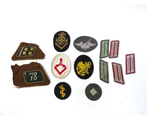 A quantity of insignia including German chevrons, Luftwaffe Flak Artillery and Kriegsmarine Engineer Room, Army Medic trade p