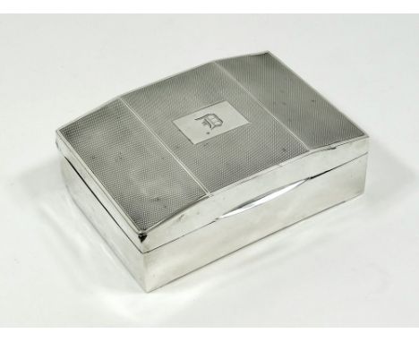 CIGARETTE BOX. An engine turned silver cigarette box, with monogram.Please note that all items in this auction are previously