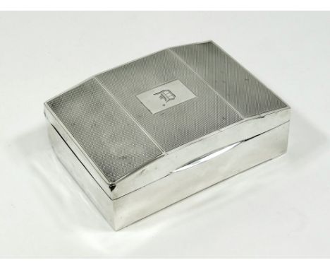 CIGARETTE BOX. An engine turned silver cigarette box, with monogram.Please note that all items in this auction are previously