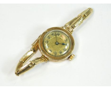 GOLD WATCH. A lady's early 20th century, 14k. cased wristwatch on 14k. expanding bracelet strap.  All watches in this auction