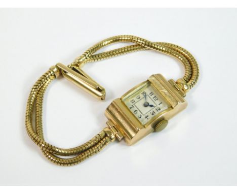 GOLD WATCH. A lady's square dial wristwatch on 9ct. gold, double snake link bracelet strap.  All watches in this auction are 