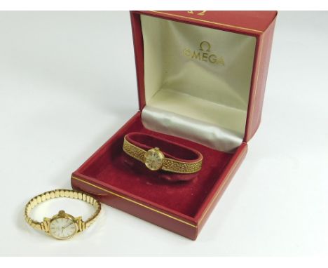 OMEGA. A lady's 9ct. gold cased Omega wristwatch on 9ct. gold textured, flexible strap. Also a lady's gold plated Omega wrist
