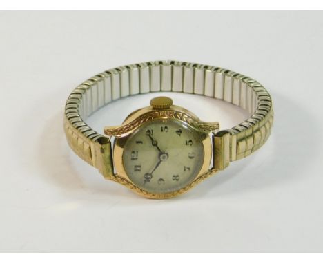 GOLD WATCH. A lady's 9ct. gold cased wristwatch with decorative bezel, on later gold plated strap.  All watches in this aucti