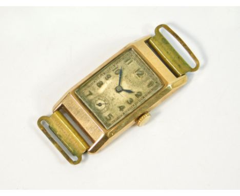 GOLD WATCH. A vintage, rectangular gold cased Rolco wristwatch, case 3.5 x 1.8cm.  All watches in this auction are previously