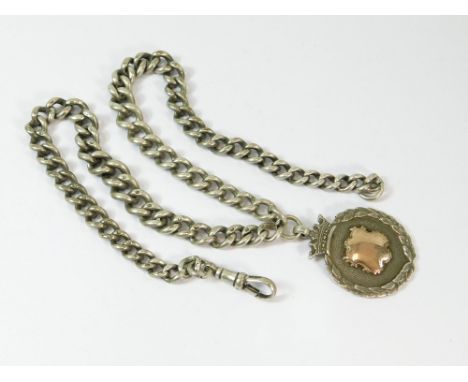 WATCH CHAIN. A silver graduated curb link watch chain with silver & silver gilt fob attached. Approx. 73g. (2.3 t.oz.) - (fob