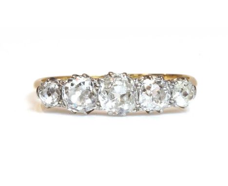 A five stone graduated diamond ring,with graduated old European and cushion cut diamonds, all claw set in white collets. Yell
