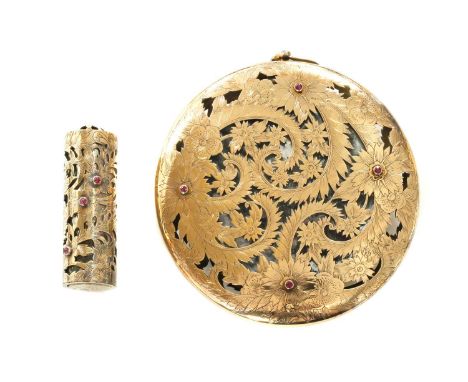 A silver and gold ruby set compact and lipstick holder, by Boucheron, with pierced engraved floral decoration. The circular c
