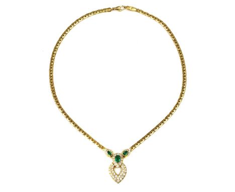 An 18ct gold emerald and diamond necklace, by Garrard &amp; Co., c.1988,with a centrepiece composed of a central oval mixed c