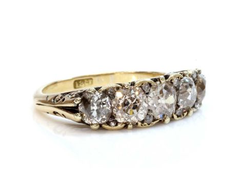 A five stone diamond carved head ring,with five graduated old European cut and cushion cut diamonds, all claw set to a carved