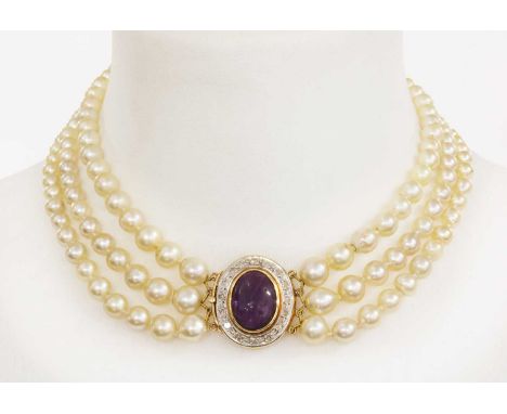 A three row graduated cultured pearl necklace with an amethyst and diamond cluster clasp,with three rows of graduated culture