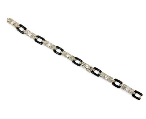 An American Art Deco diamond and enamel bracelet, c.1920,with a series of pierced rectangular plaque links. Each plaque with 
