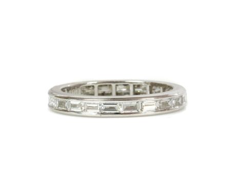 An 18ct white gold diamond set full eternity ring, with a row of baguette cut diamonds, with a total stated weight of 1.27ct,