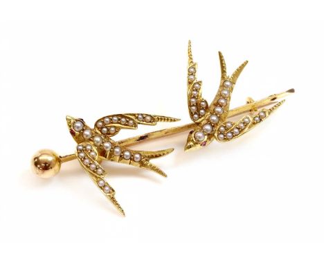 A gold and split pearl swallow brooch, c.1900,with a pair of swooping swallows, grain set with graduated split pearls, mounte