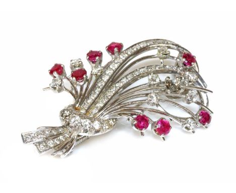 A ruby and diamond spray brooch, c.1950,with central reed style leaves, grain set with rows of eight cut diamonds. Radiating 