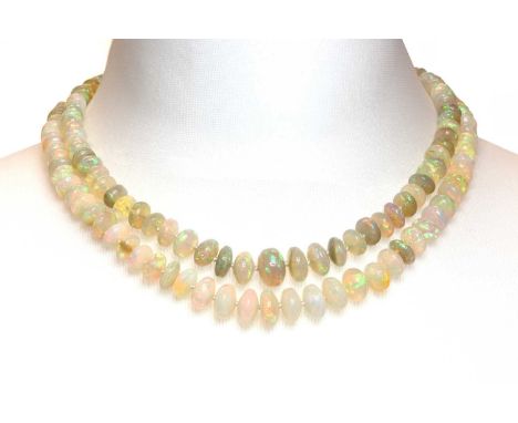 A two row graduated opal bead necklace,with an opal, sapphire and diamond two row clasp. Two rows of graduated bouton shaped 