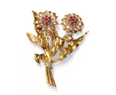 A three colour gold, ruby and diamond spray brooch, c.1940,with two flower head clusters. Each one composed of a cluster of c