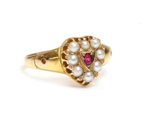 A 15ct gold Victorian ruby and split pearl heart shaped cluster ring,with an oval Swiss cut ruby, grain set to the centre. A 