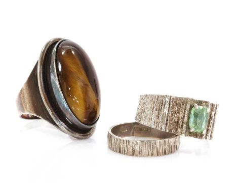 A single stone green tourmaline ring, attributed to Iris Oakes, c.1970, with a cushion cut green tourmaline, four claw set to