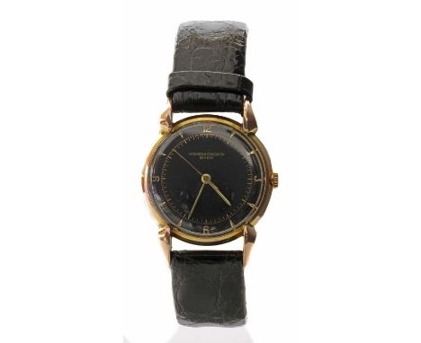 A gentlemen's 18ct gold Vacheron Constantin mechanical strap watch, c.1940,with a 30mm case. A black dial with raised gold nu