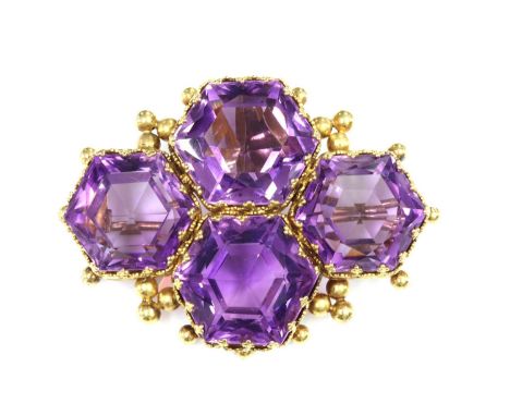 A late Victorian amethyst brooch,with a later pendant bale, composed of four hexagonal mixed cut amethysts, in a lozenge clus