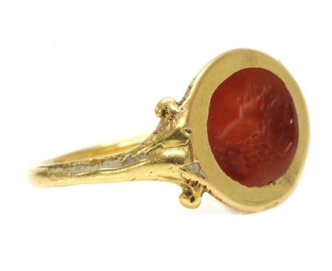 A gold cornelian intaglio ouroboros ring,possibly Roman, with a carved cornelian intaglio depicting a lady in profile, Roman 