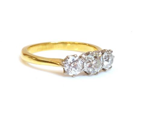 A gold three stone diamond ring,with three old European cut diamonds, with a total estimated diamond weight of approximately 