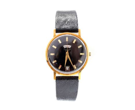 A gentlemen's 18ct gold Jean Perret Genève automatic strap watch,with a 34mm case. A black dial, raised gold batons, gold swo