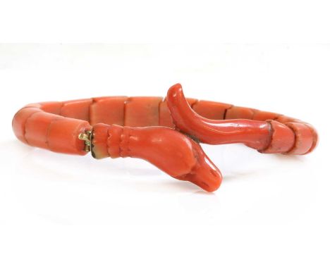 A late Victorian carved coral graduated snake bracelet, or semi flexible bangle, with a series of carved, fluted segments, to
