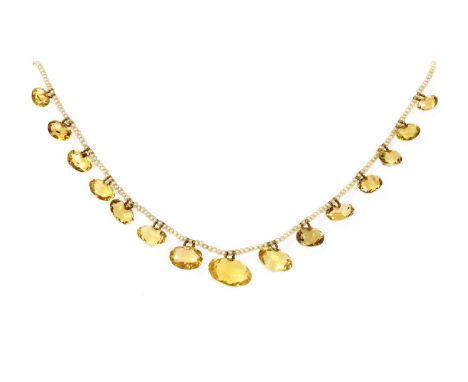 A late Victorian seed pearl and citrine fringe necklace,with a series of graduated oval mixed cut citrines, strung on gold wi