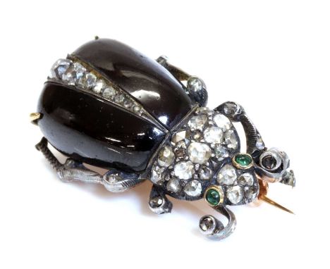 A former Austro-Hungarian garnet and diamond beetle brooch, c.1870,with carved garnet elytra. A row of graduated cushion shap