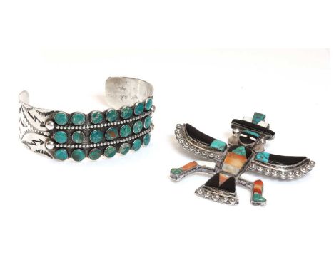 A native American silver Zuni 'bird man' brooch,with inlaid onyx, turquoise and red oyster, with applied bead decoration. Sig