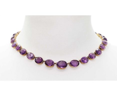 A late Victorian graduated amethyst rivière necklace,with a series of graduated oval mixed cut amethysts, each one claw set i