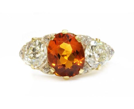 A late Victorian citrine and diamond boat shaped carved head ring,with an oval Madeira citrine, claw set to the centre. An ol
