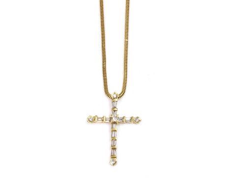 A Latin style diamond set cross and chain, with a brilliant cut diamond, four claw set to the centre. Tapered baguette cut di