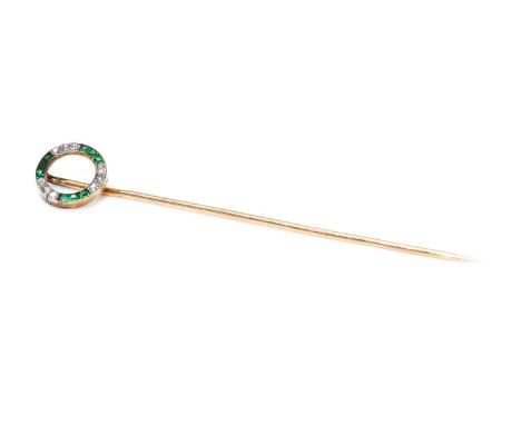 A French Art Deco emerald and diamond stick pin,  with an open hoop of calibré cut emeralds and old European cut diamonds. Th