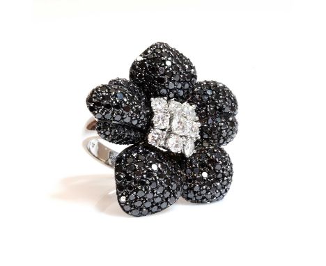 A Continental white and black diamond orchid ring, c.1990,with a central cluster of brilliant cut diamonds, forming the stigm