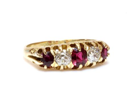 An 18ct gold red spinel, ruby and diamond boat shaped ring, c.1900,with an oval mixed cut spinel, claw set to the centre. An 