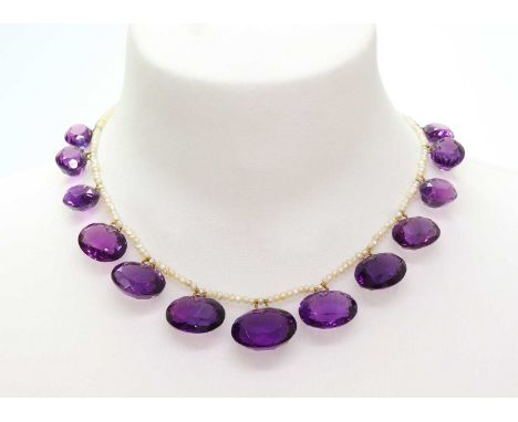 A Victorian seed pearl and amethyst fringe necklace,with a series of thirteen graduated oval mixed cut amethysts, all suspend
