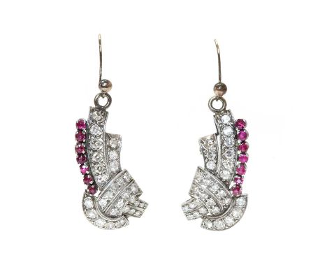 A pair of ruby and diamond drop earrings,converted from a double clip brooch, c.1930. Two rows of graduated eight cut diamond