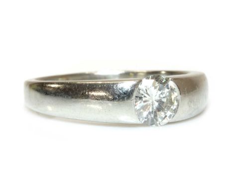 A platinum single stone gypsy or Prussian style ring,with a brilliant cut diamond, estimated as approximately 0.80ct, end set