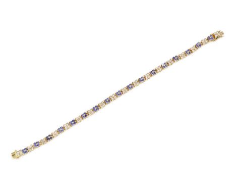 An 18ct gold sapphire and diamond line bracelet,with alternating sets of quatrefoil cluster heads. Four brilliant cut diamond